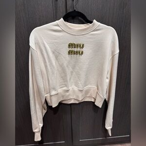 Miu Miu sweater shirt with lime green and brown lettering.